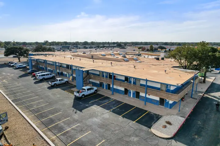 Aerial view of the two-story building and guest parking