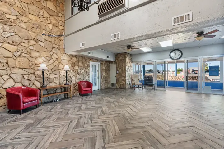 Lobby with a stone wall, seating and front doors