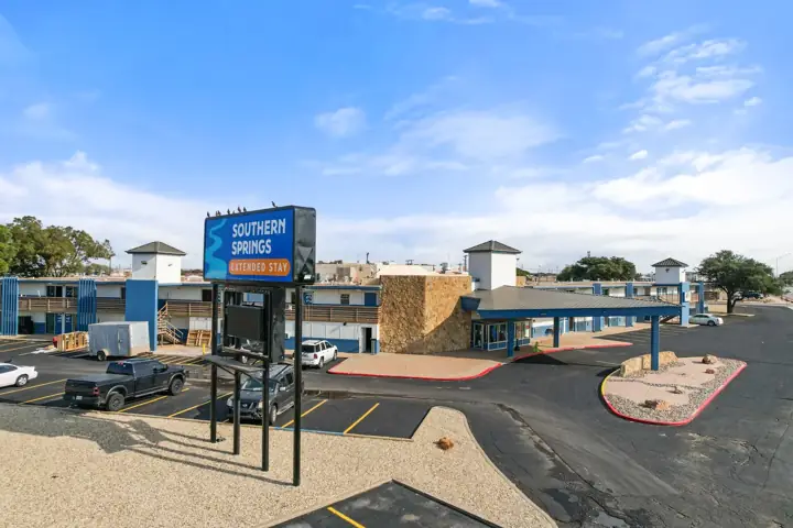 Southern Springs Extended Stay sign and parking lot on Avenue Q in Lubbock